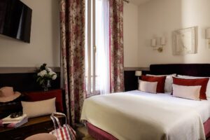 hotel room with one large bed and curtains - hotel near maillot museum